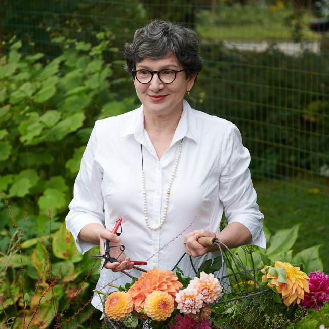 Frances Palmer holding a basket of dahlias